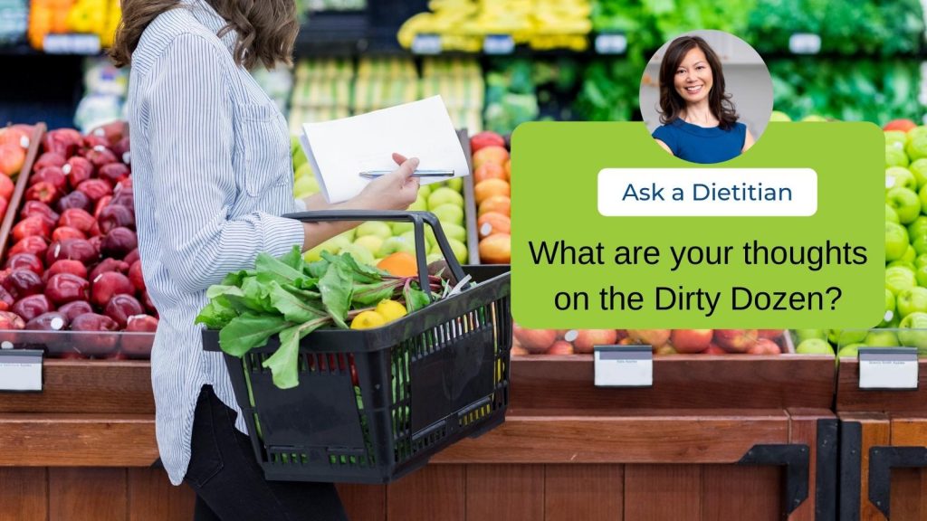 A woman shopping for veggies at a grocery store. A headshot of Sue is overlayed with the text "Ask a Dietitian. What are your thoughts on the Dirty Dozen?" 
