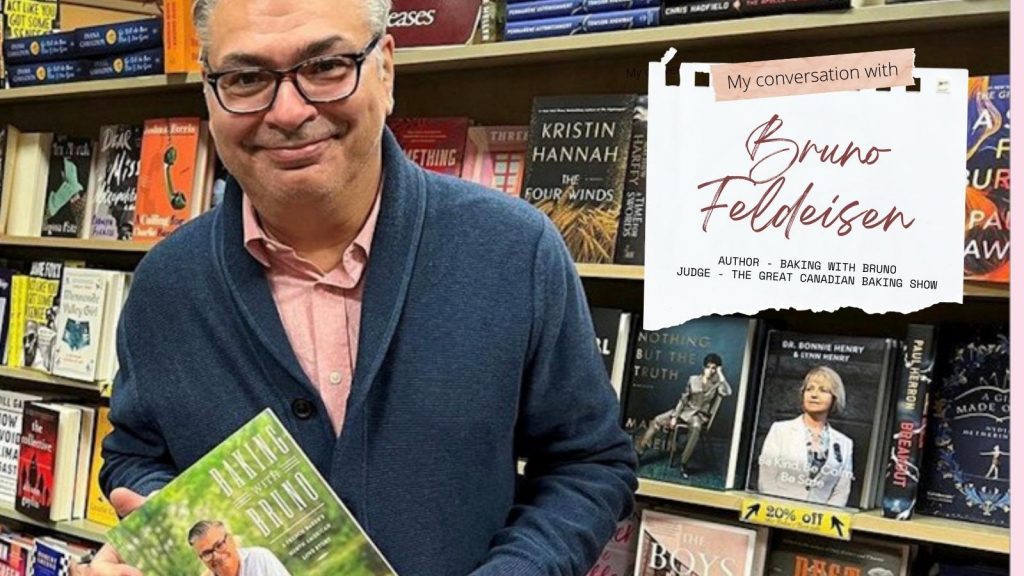 Chef Bruno standing at a bookstore and holding his cookbook