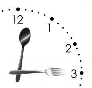 Clock made of spoon and fork, isolated on white background