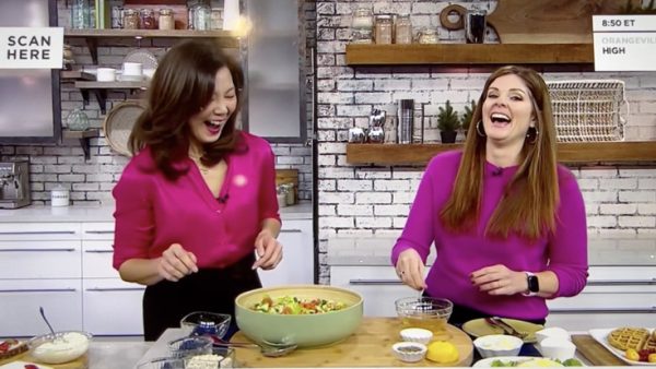 Sue Mah and TV host Lindsey Deluce in the TV studio kitchen cooking