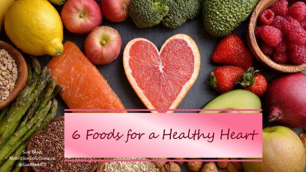 A variety of heart healthy foods such as salmon, apples, broccoli, grapefruit and berries.
