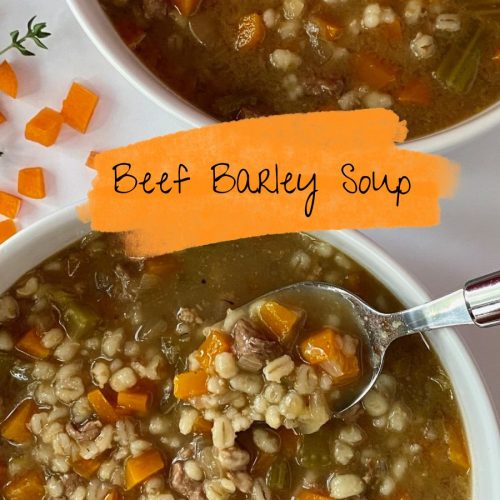 A bowl of beef barley soup, served with a green spoon.