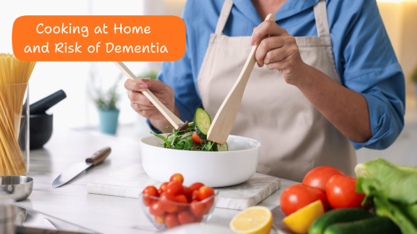 A person wearing an apron and tossing a salad in the kitchen