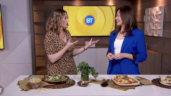 TV host Dawn Chubai and Sue standing on the BT TV set