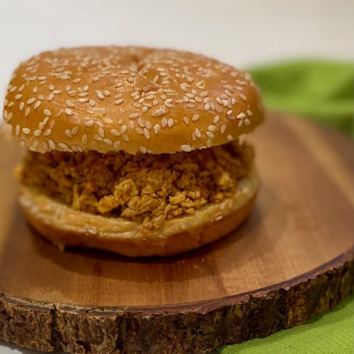 Shredded tofu burger on a sesame bun.