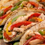 Chicken fajitas with red, green and yellow bell peppers